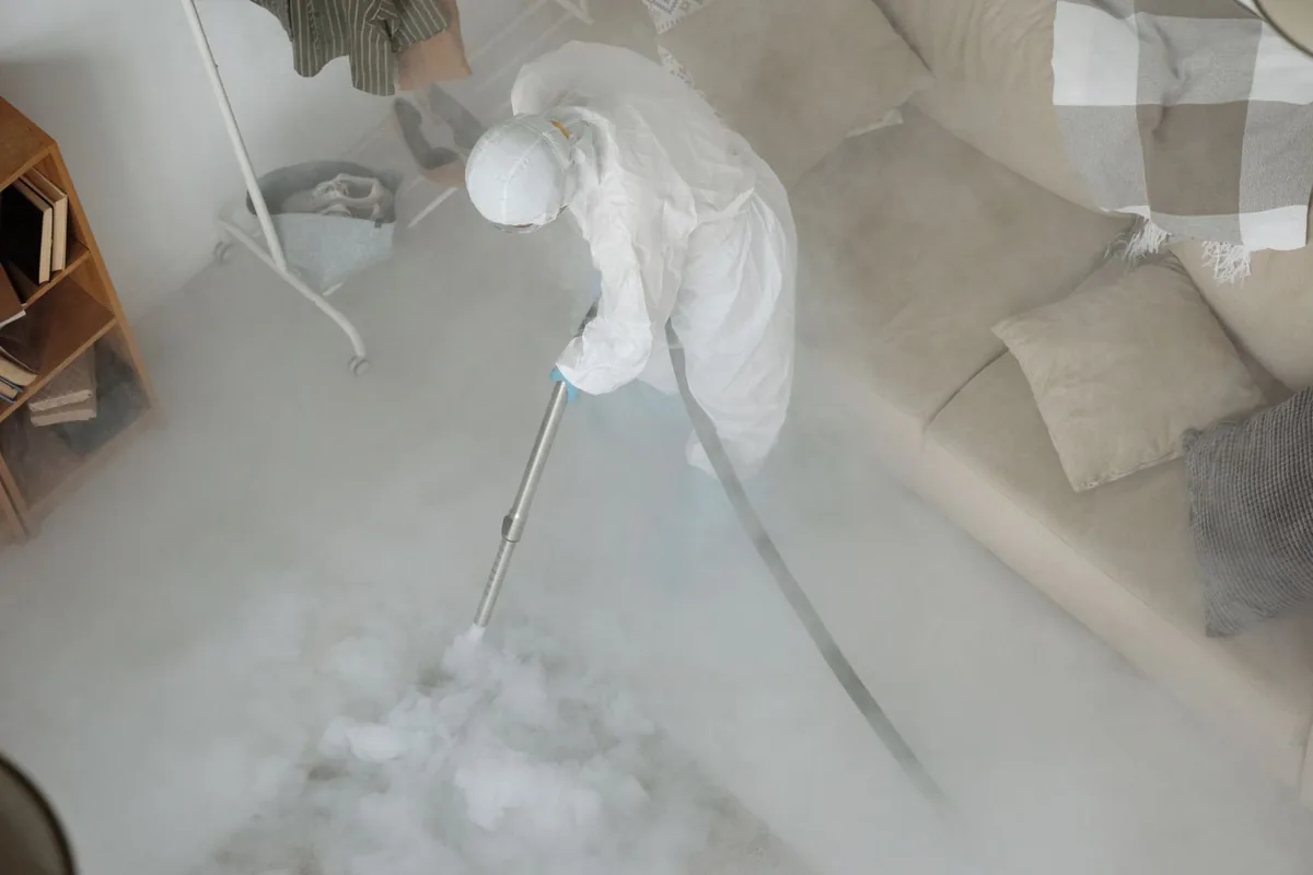 Biohazard cleanup technician in protective equipment, Trenton, OH